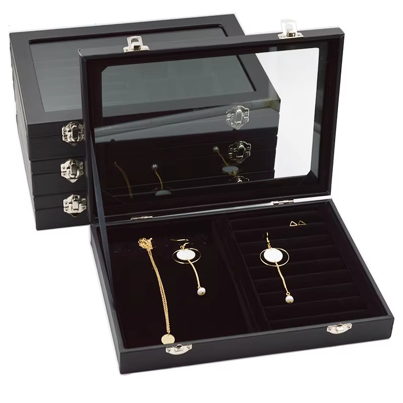 Black jewelry box with earrings inside, featuring the brand 'ROMAN DECOR'.
