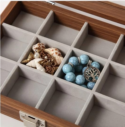 Jewelry box with compartments containing jewelry items.