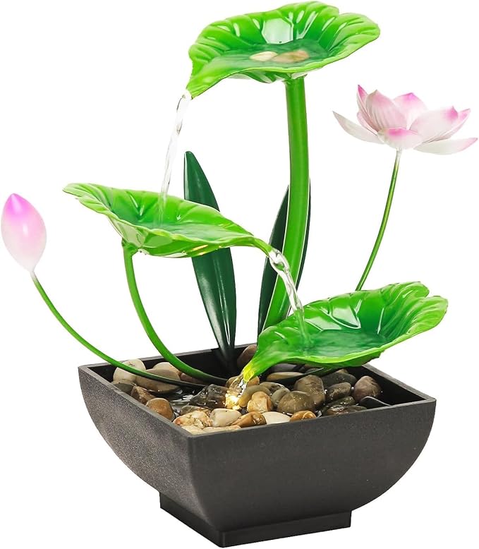 Decorative water fountain with green leaves and pink flowers in a black basin.