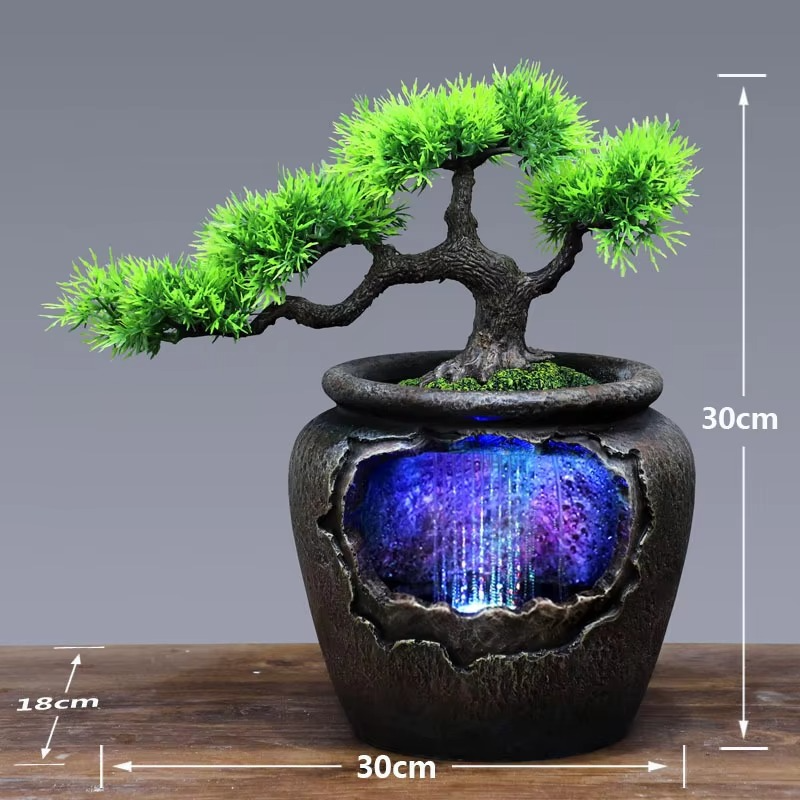 Decorative pot with a bonsai tree and LED light inside, on a wooden surface with measurements indicated.
