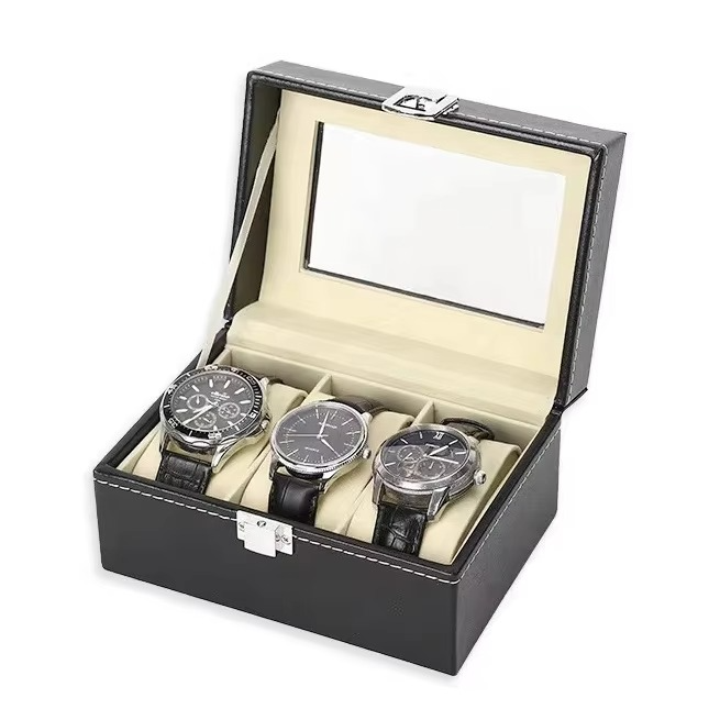 Black watch box with three watches inside on a white background