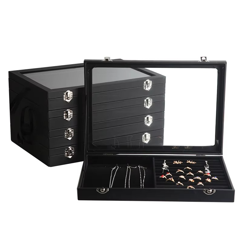 Black jewelry display case with jewelry inside on a white background