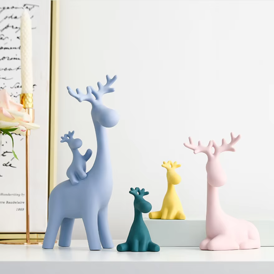 Set of colorful deer figurines on a shelf with a light background