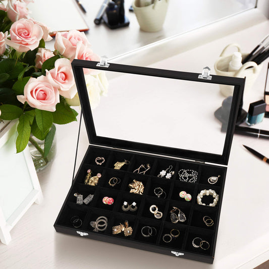 Jewelry box with earrings on a table with flowers and makeup items.