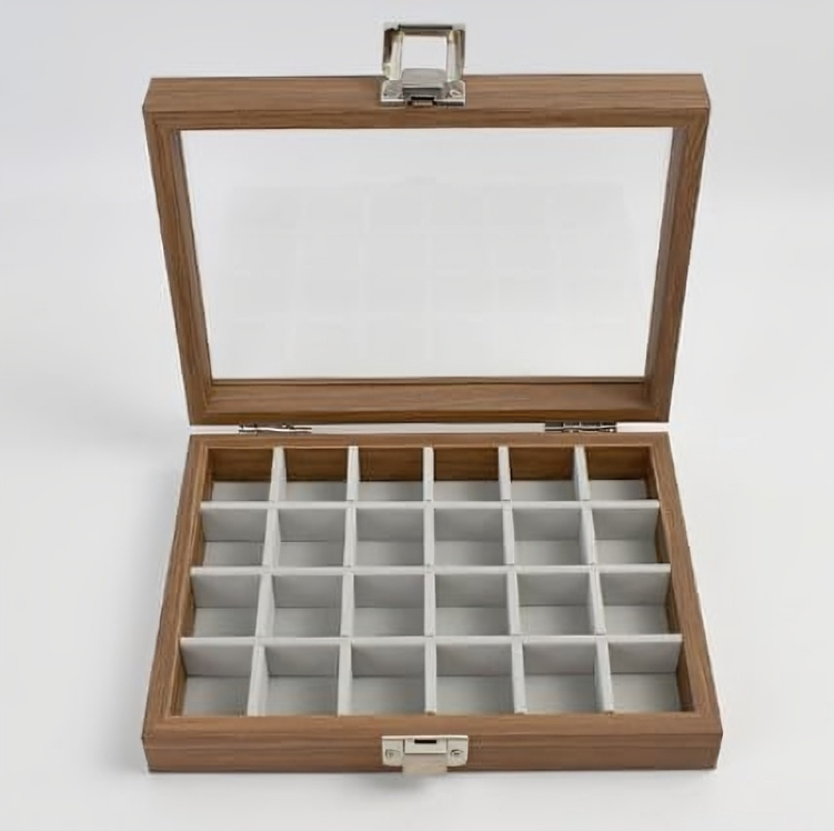 Wooden jewelry box with glass lid on a white background