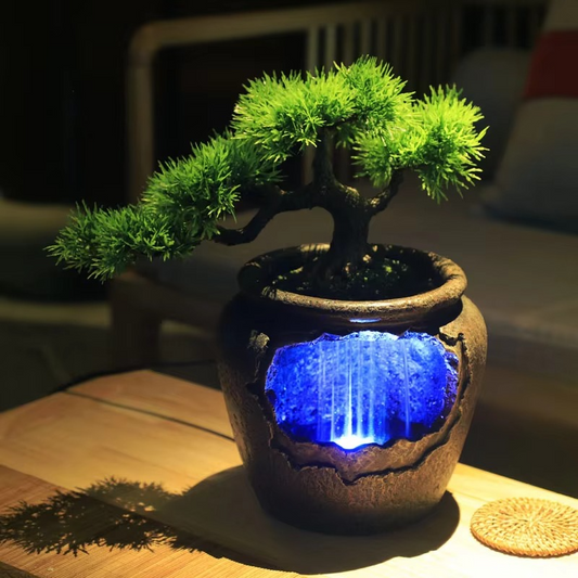 Potted bonsai tree with a blue light inside on a wooden surface